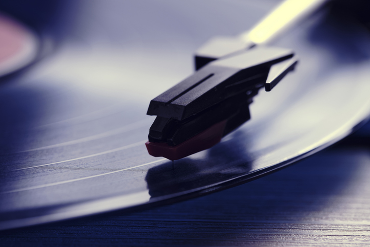 Classic vinyl record player closeup with contoured daylight from window.