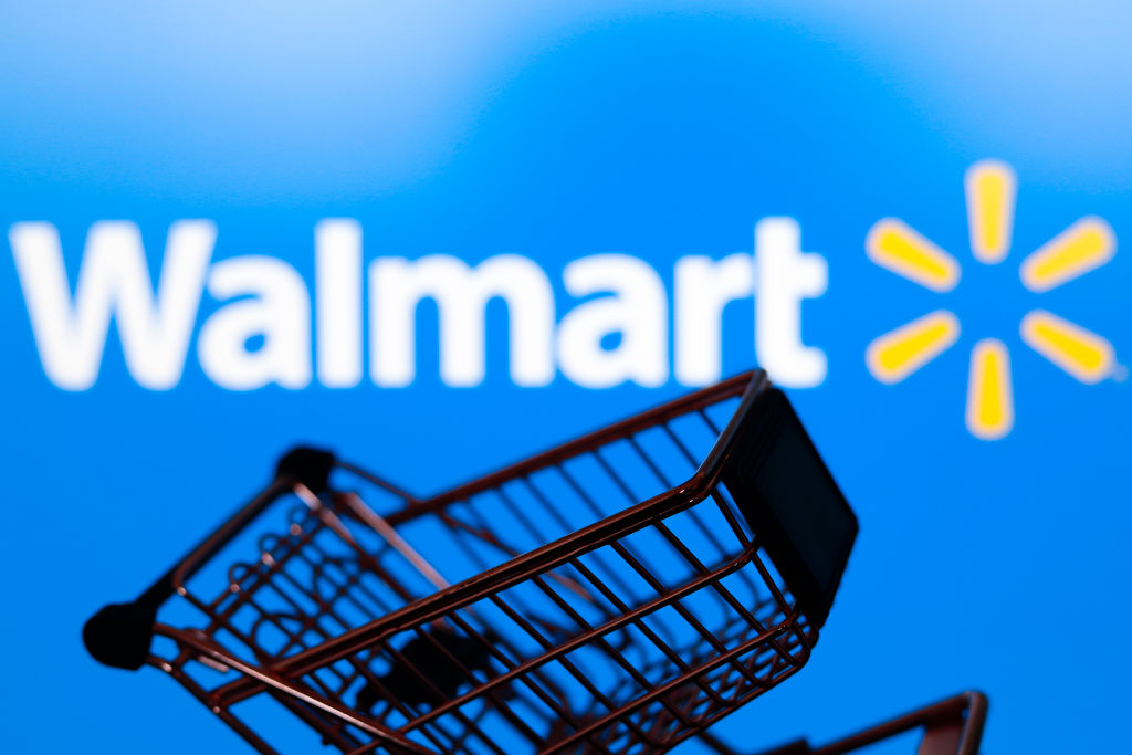 In this photo illustration, a shopping cart is seen in front...