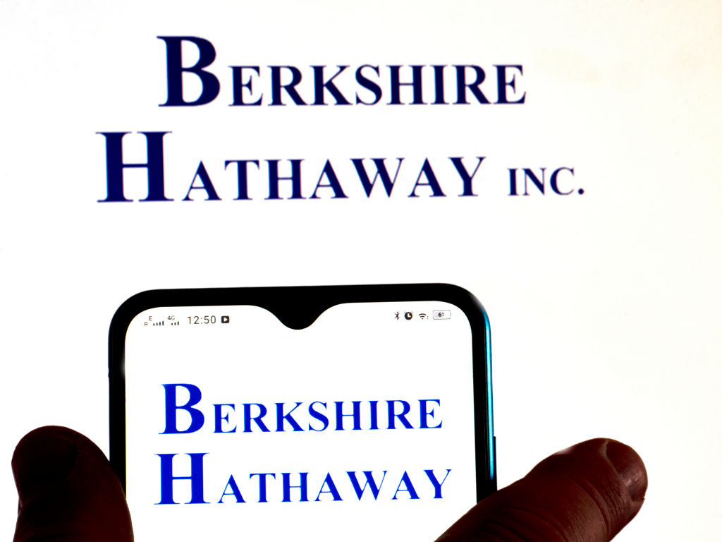 In this photo illustration, the Berkshire Hathaway logo is...