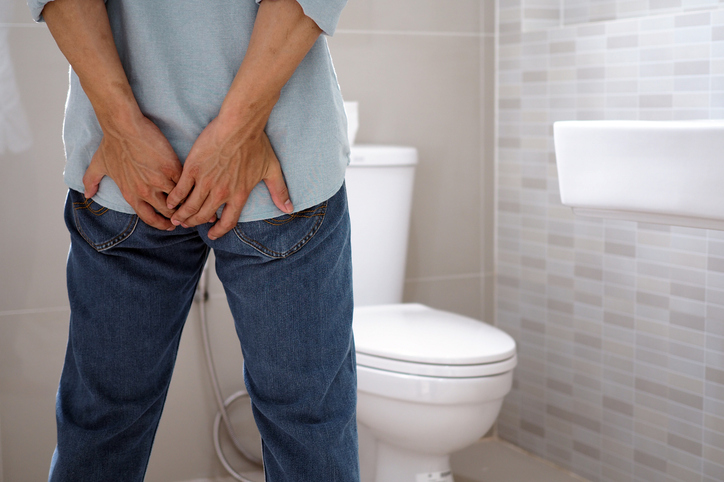 Rear View Of Man Standing In Toilet At Home