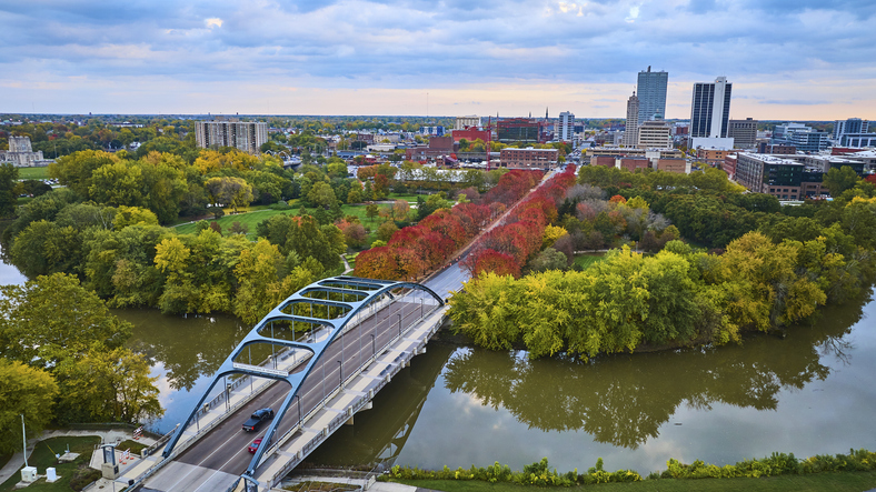 Aerial Autumn Cityscape with Modern Bridge and River at Sunrise