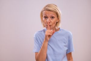 Mature woman with finger on her lips