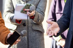 Midsection Of People Holding Microphone By Man