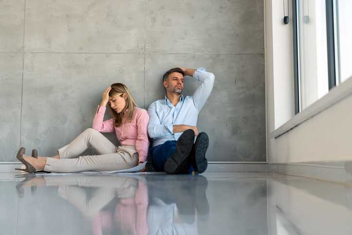 Weary Business Professionals Taking Break on Office Floor