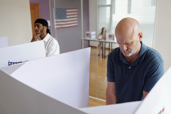 Men Voting In Booth In Centre