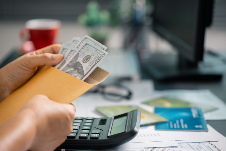 Person manage finances wisely, saving cash from their salary to ensure stable income for future payments and business investments. currency, money, saving, cash, hand, finance, financial, income.
