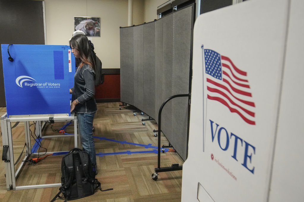 People vote inside one of the vote centers at University of...