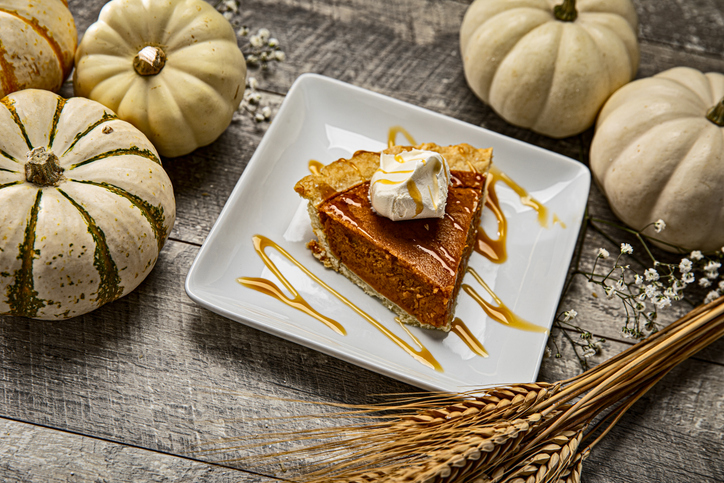 Pumpkin Pie and Autumn White pumpkins with Babys Breath flowers on wood background