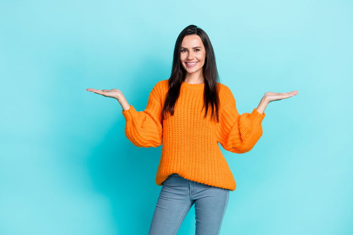 Portrait of positive nice person arms palms hold empty space proposition isolated on emerald color background