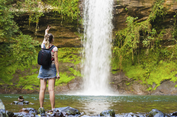 Jung woman in front of waterfall, Maquine, Rio grande do sul, Brazil, South America