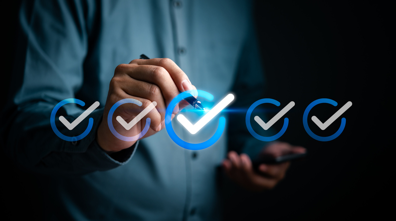 Hand marking approval ticks on a holographic checklist interface. Highlights task completion, management, and corporate productivity.