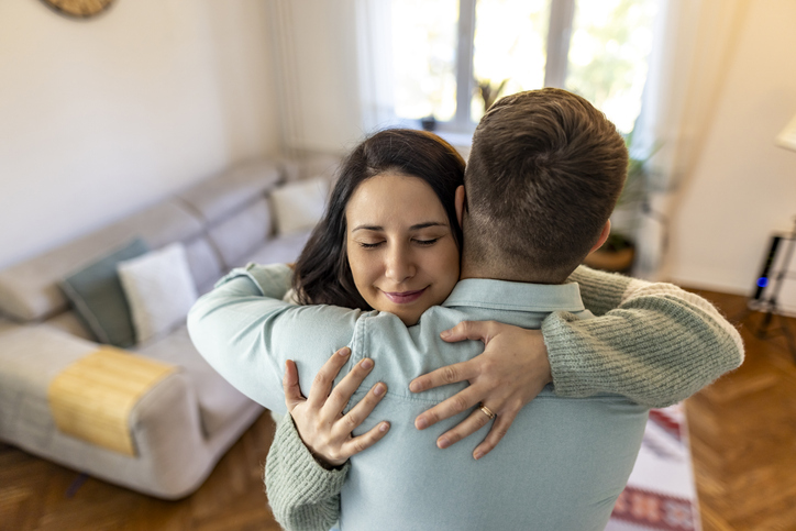 Loving Couple Embracing in a Cozy Home Living Room Setting