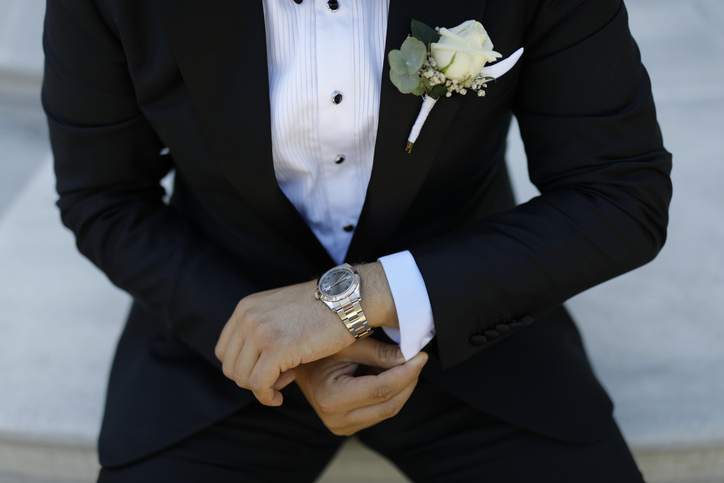 Waiting Patiently: A Man Checking His Watch Before an Event