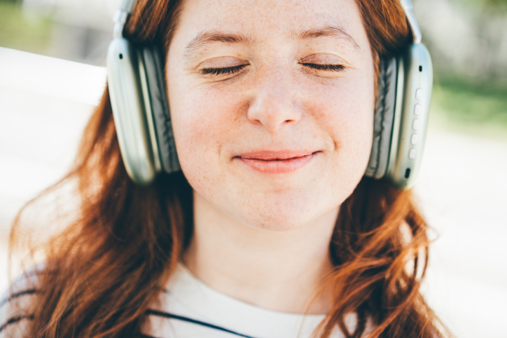 A woman enjoys her favorite music.