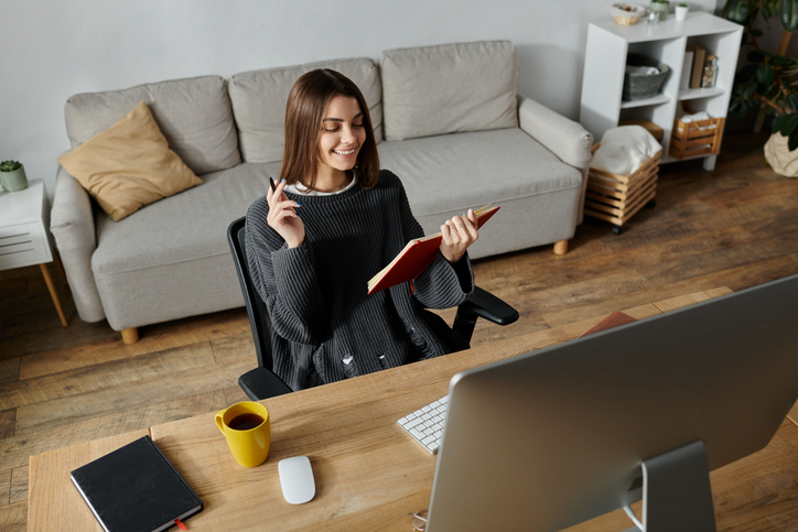 Young woman enjoys creative writing session at stylish home office in cozy atmosphere