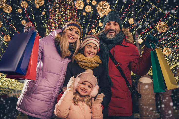 Portrait of attractive cheerful family spending eve festal event gathering buying gifts things having fun occasion city urban outdoors
