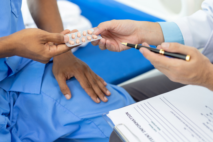 Doctor gives medication advice to a male patient with symptoms of sexual dysfunction, Male health problems. Health consultants and disease treatment from specialized doctors in the hospital.