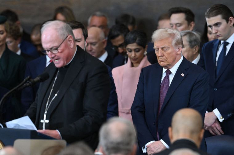 Archbishop of New York Cardinal Timothy Dolan (L) delivers the invocation during the inauguration ceremony.