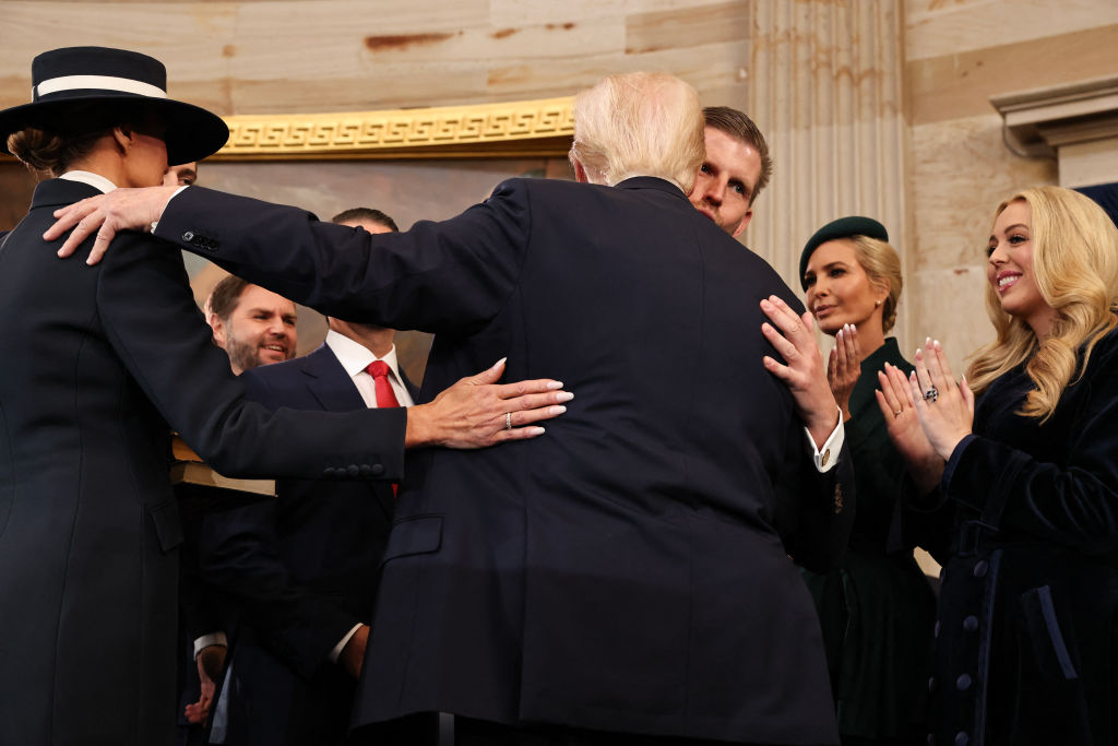 Donald Trump hugs his family after taking the oath of office during inauguration