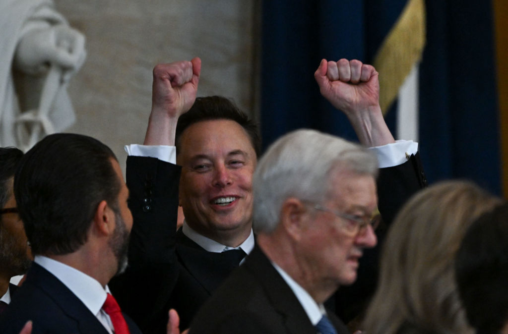 Tesla CEO Elon Musk reacts as newly sworn-in President Donald Trump speaks during the 60th inaugural ceremony