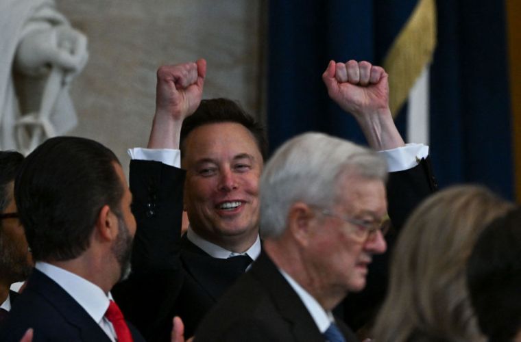 Tesla CEO Elon Musk reacts as newly sworn-in President Donald Trump speaks during the 60th inaugural ceremony