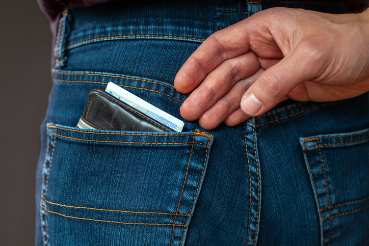 pickpocket, thief stealing money from the pocket