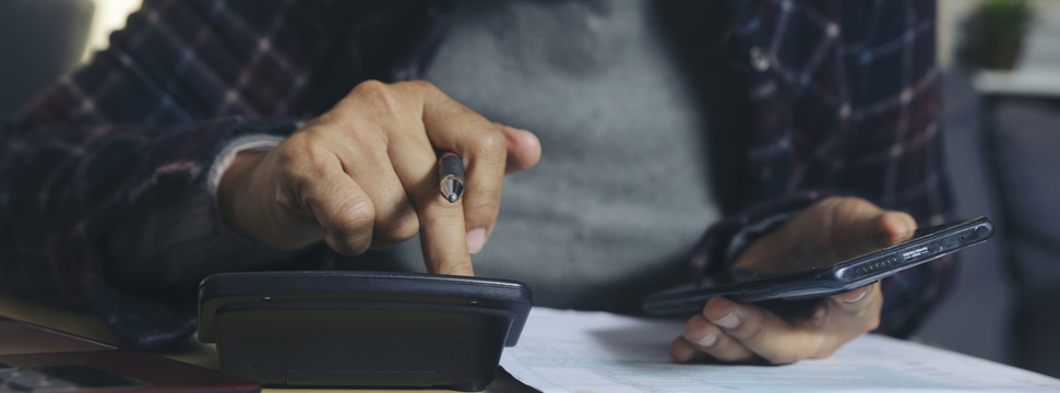 Budget and Tax planning concept. Acountant hand using calculator and review tax form. Represents personal finance, tax preparation, and budgeting, season to pay tax-banner image.