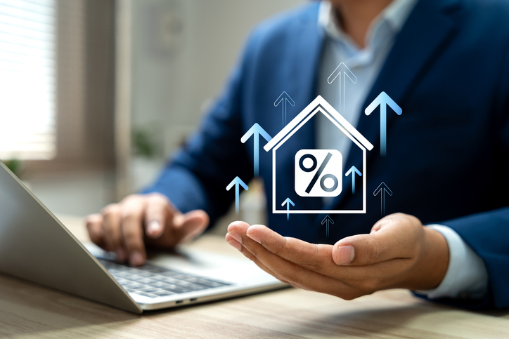 Real estate market growth, Hand holding house model with upward arrows and percentage signs, Symbol property investment and mortgage rate trends. Property investment insights, Future in housing market