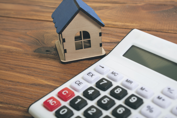 a house and a calculator on the table