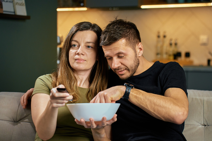 Couple Watching TV and Eating Snacks