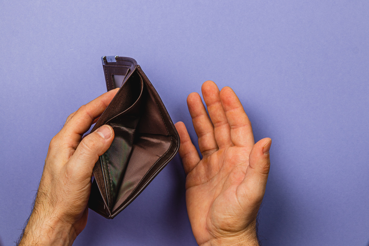 Financial crisis reflected in an empty wallet showing the burden of despair