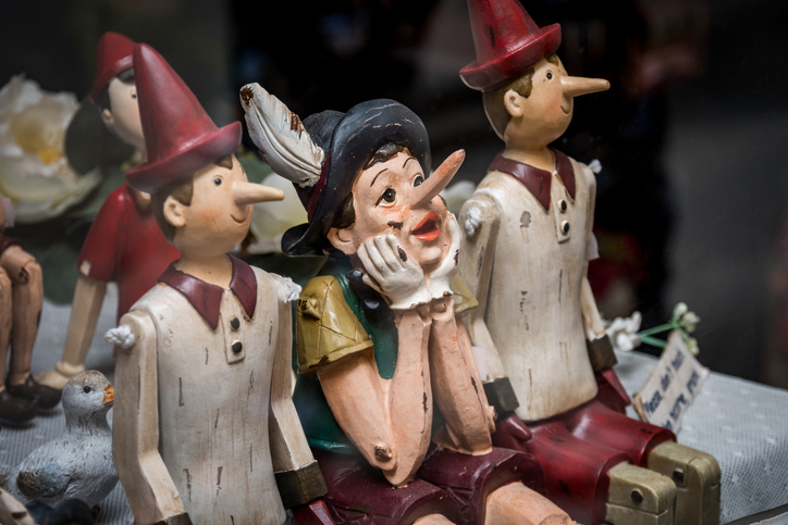 Siena, Italy, April 2018: Wooden statue of Pinocchio with donkey ears and long nose