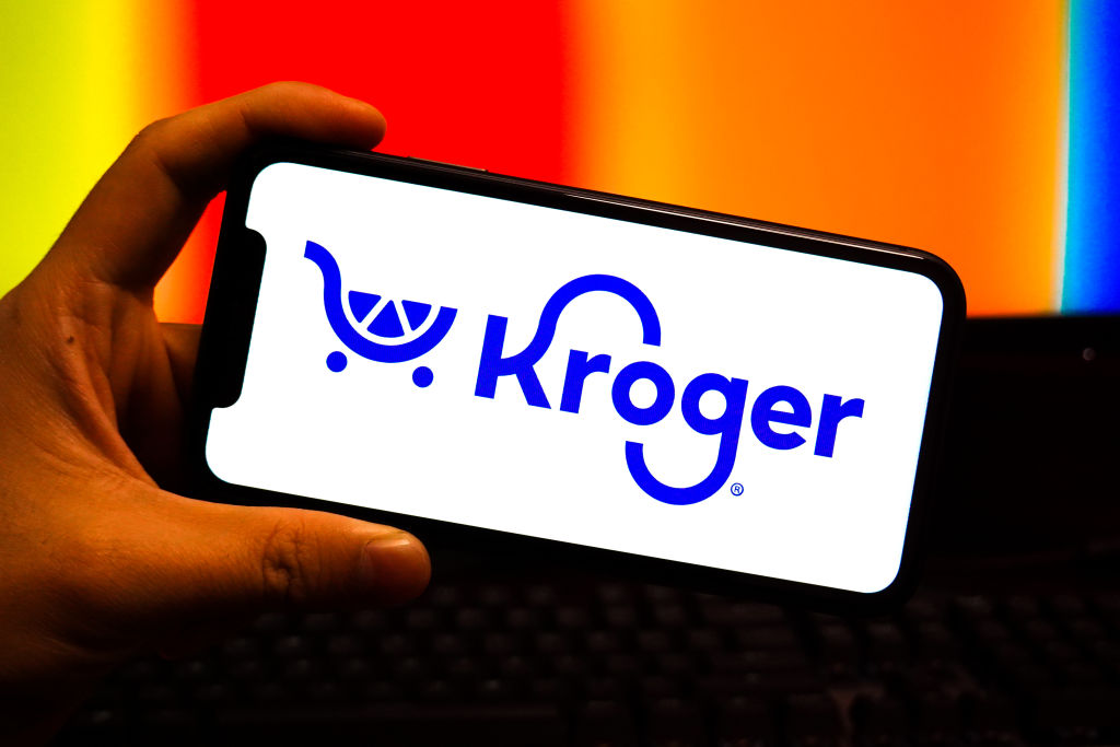 In this photo illustration, a kroger logo is displayed on...