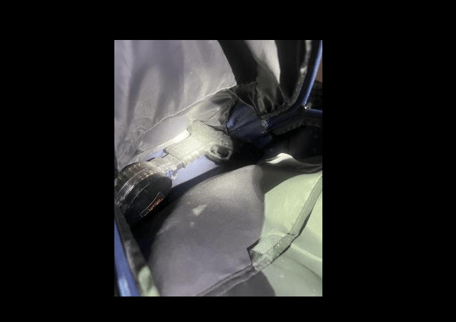 Handgun with an extended magazine and a machine gun conversion device.