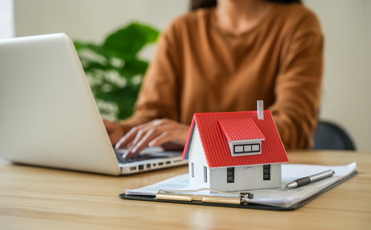 Increasing interest rates for people filling out information and model homes Interest rate hikes, home loans, mortgages, home taxes. Investment and asset management concepts.