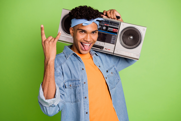 Photo of guy hold recorder show horns tongue out wear headband jeans shirt isolated green color background