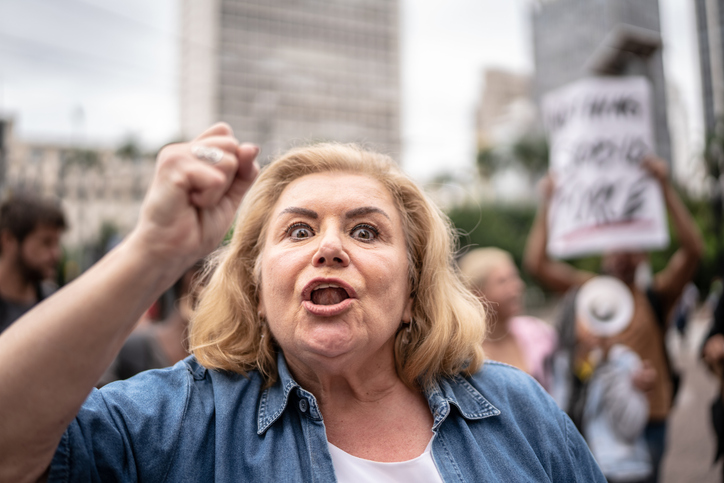 Portrait of a senior woman leading protest