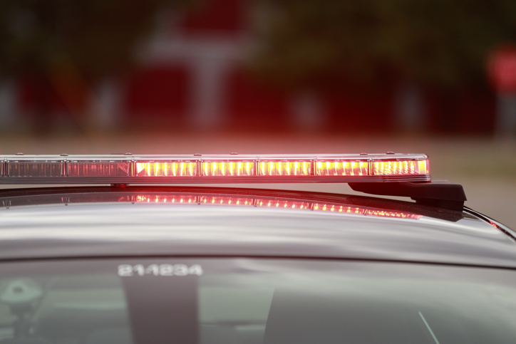 Police LED lights flashing at the scene of a shooting