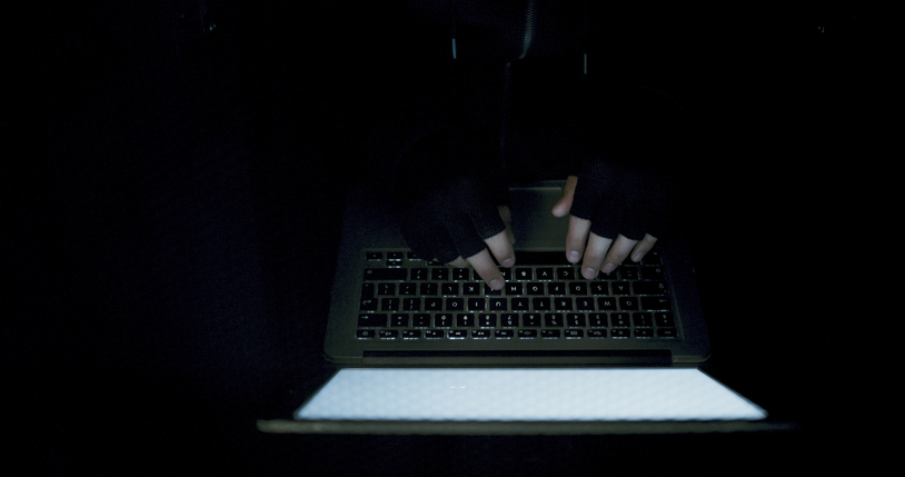 Night, hacking and hands of person on laptop from above in cyber crime, internet fraud or malware. Typing, darknet and hacker in mockup for data breach, ransomware or criminal network in dark space
