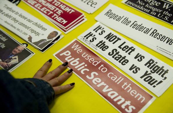 A woman looks over bumper stickers for s