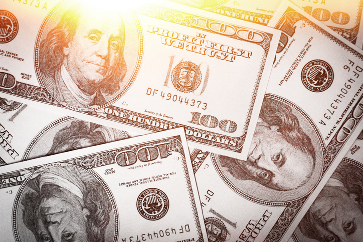 Background from dollar bills. Money background. Pile of money on the table. One hundred dollars.