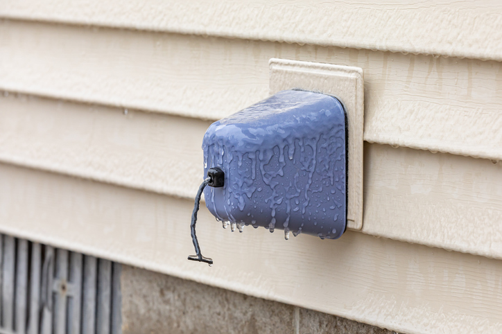 Outdoor faucet, water spigot, with ice on insulation cover.