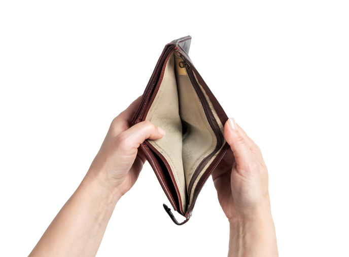 Female hands holding an open empty wallet isolated on white background. Concept of poverty, lack of money, financial crisis, and personal budget problems. File contains clipping path.