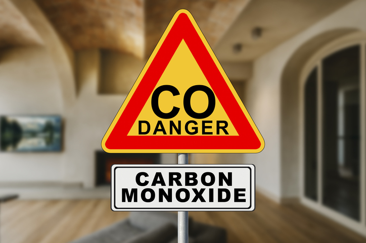 DANGEROUS CARBON MONOXIDE - Indoors Air Quality concept with home interior and alert signboard