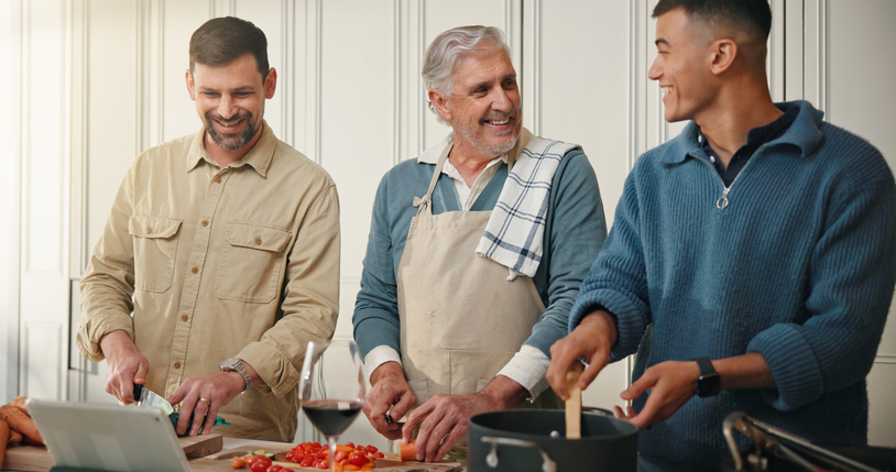 Grandfather, men and cooking in kitchen with tablet for online recipe, support or thanksgiving dinner. Happy, old man and family in home with tech for holiday meal prep, digital food app and bonding.