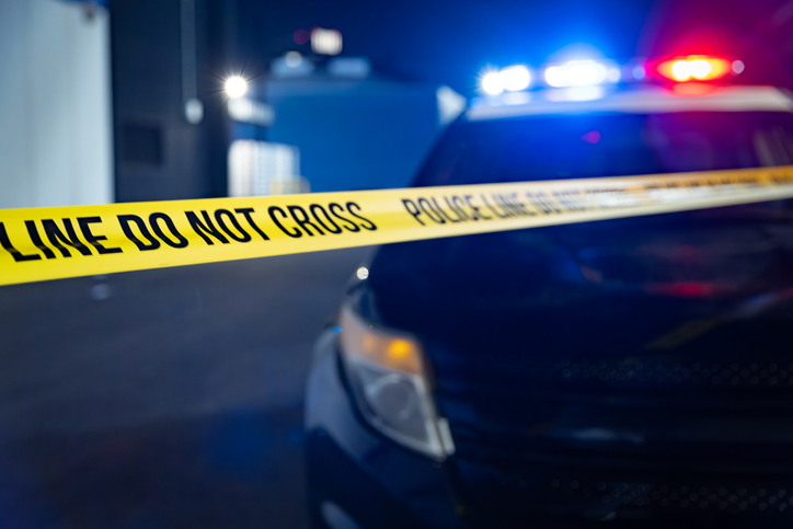 Police Tape in Front of Blue and Red Lights of Squad Car