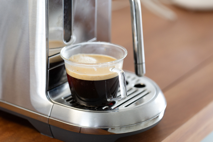 A cup of coffee on the coffee machine