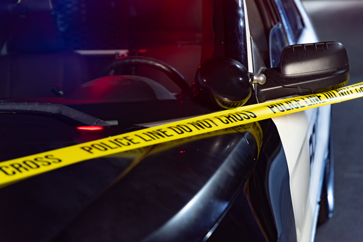 Nighttime Still Life of Barricade Tape and Police SUV