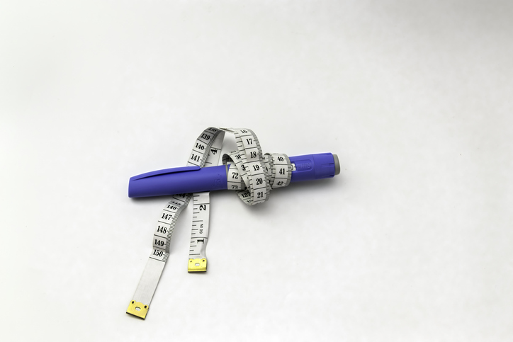 Semaglutide Injection Pen like Ozempic with Measuring Tape on White Background, copy space, isolated