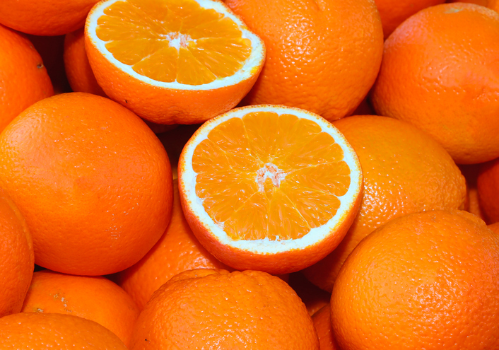 background ripe orange oranges and some cut half for sale greengrocer